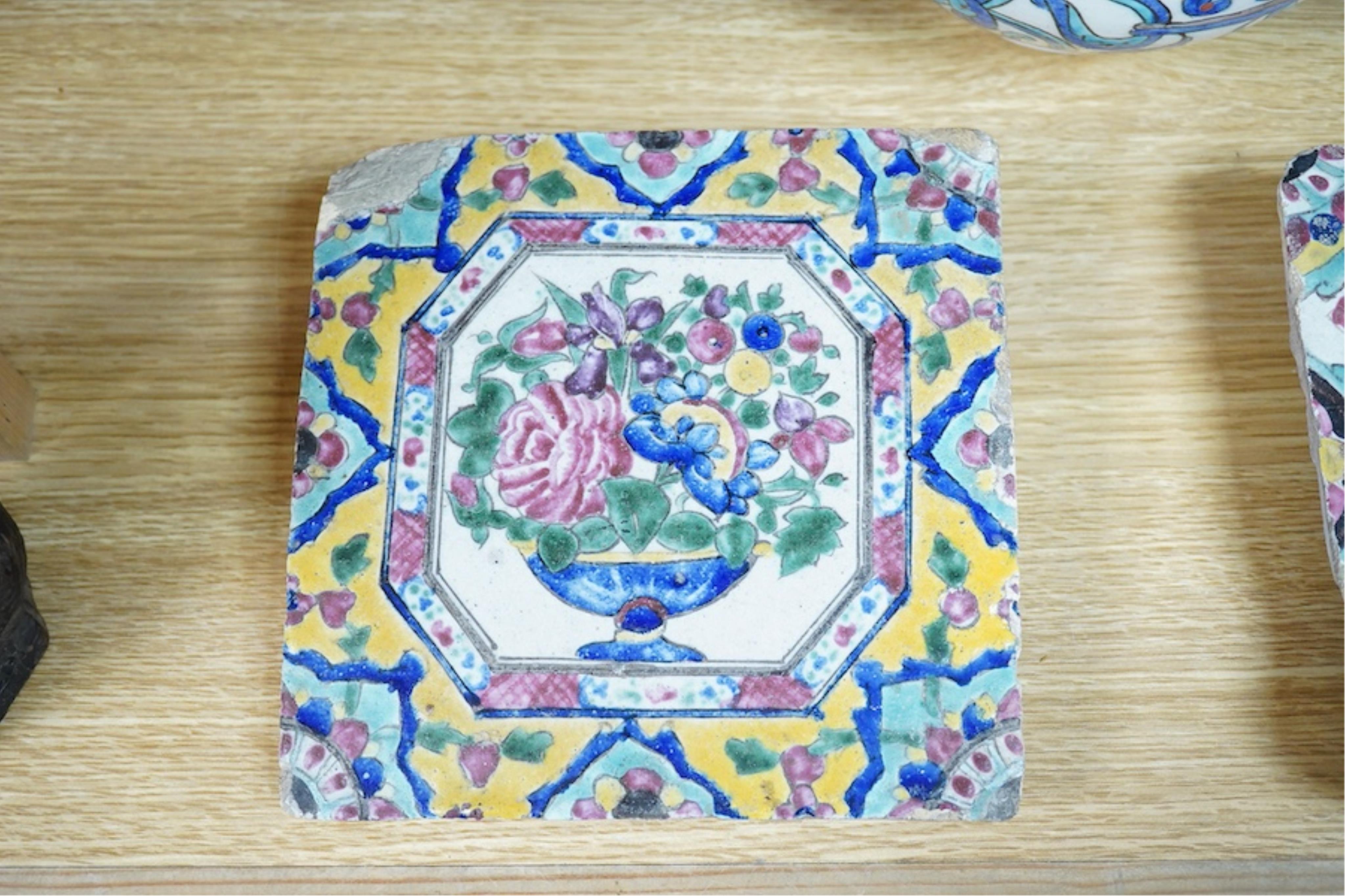 A Persian stoneware vase (reduced) and two floral tiles